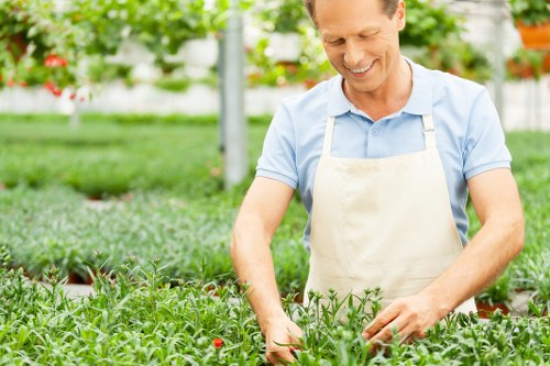 Technician sorting garden waste into recycling streams